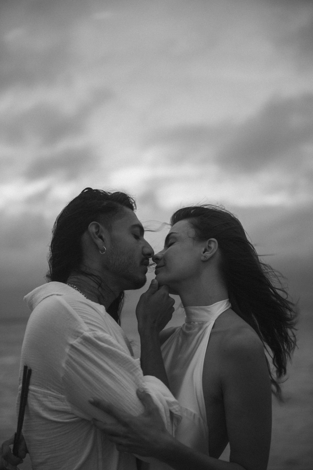 Black and white image of a romantic couple embracing each other.