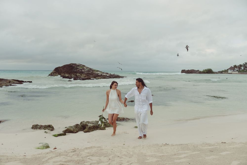 Romantic elopement featuring the couple walking together on the beach in Tulum, Mexico.