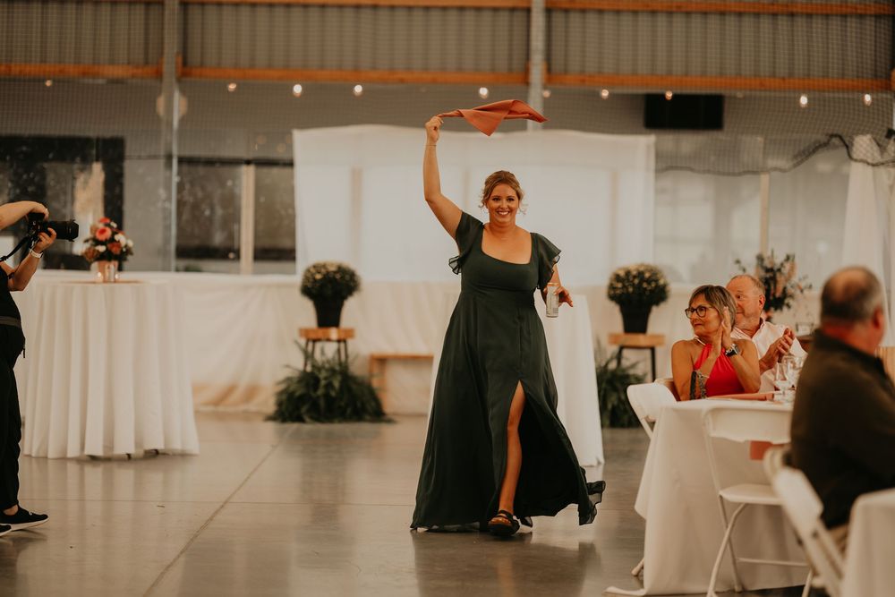 bridesmaid twirling napkin as she enters reception