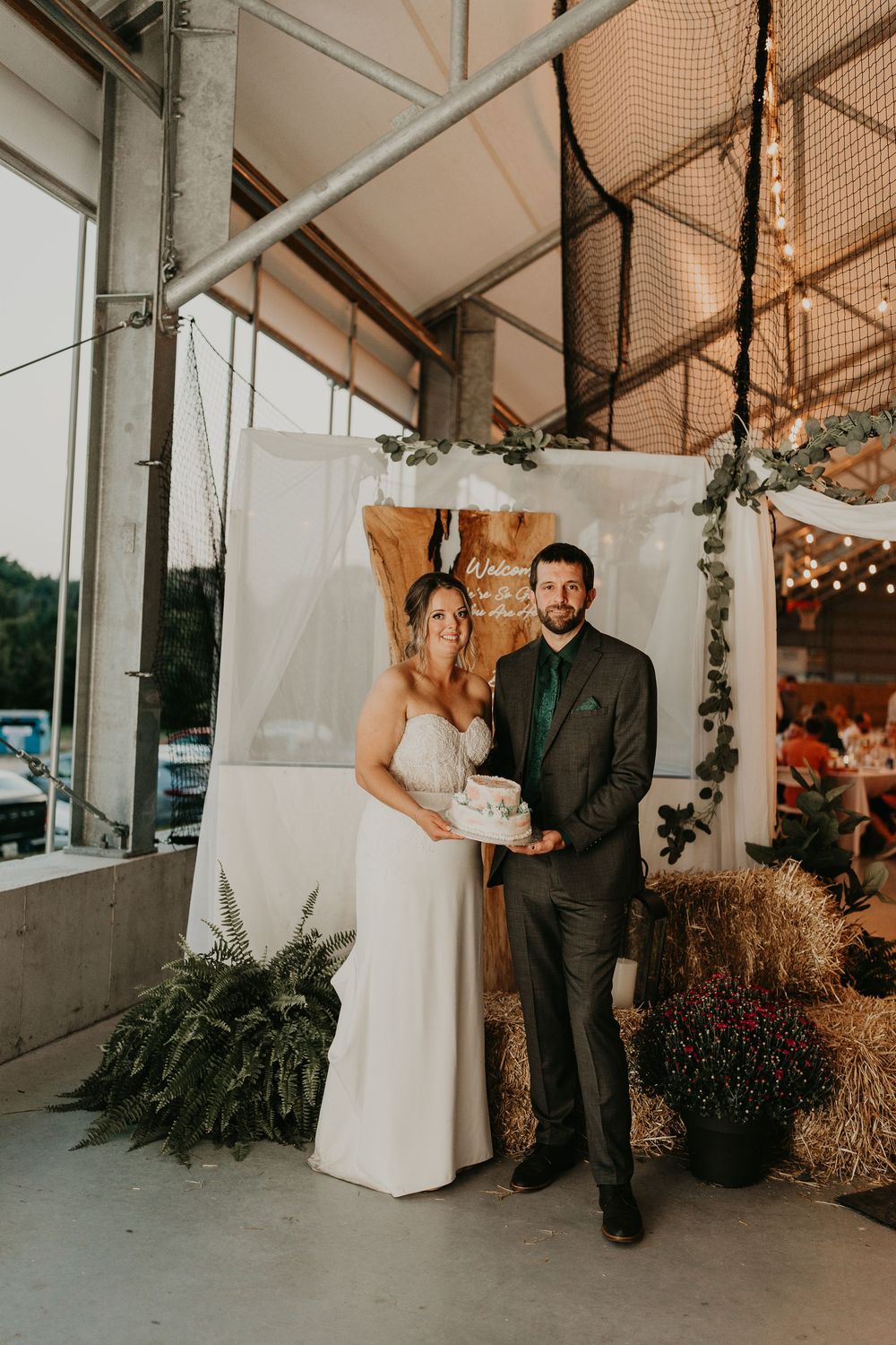 bride and groom holding their wedding cake