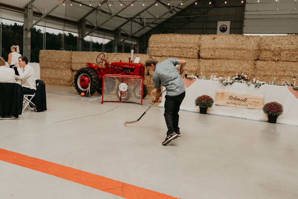 boy scoring at floor hockey at wedding reception