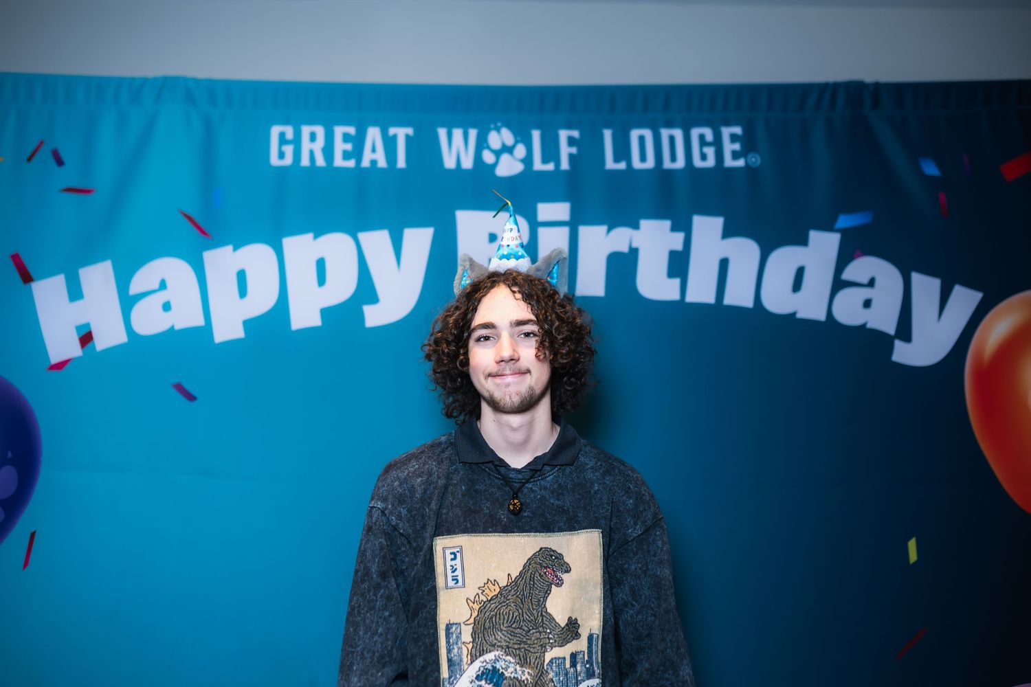 Collage of birthday party photos with blue lighting and Great Wolf Lodge branding in the background.