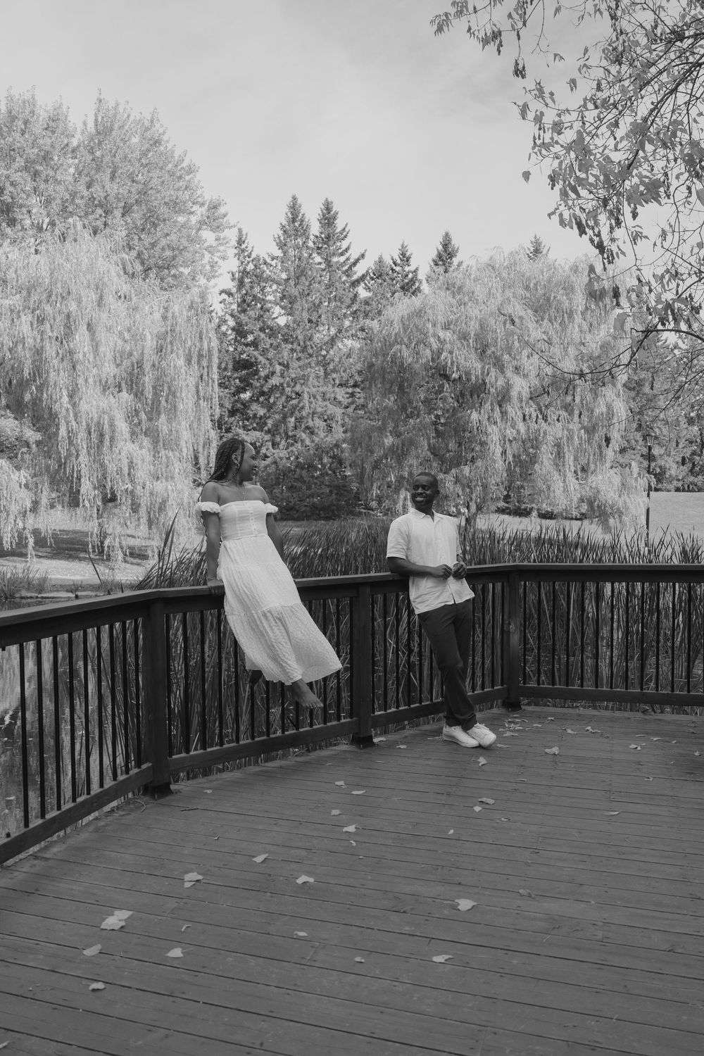 Black and white sequence of flowing fabric movement on a wooden deck surrounded by trees.