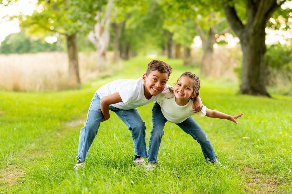 Playful sequence of couple having fun on green grass in park setting in strathroy at Mac Cuddy Botanic Garden
