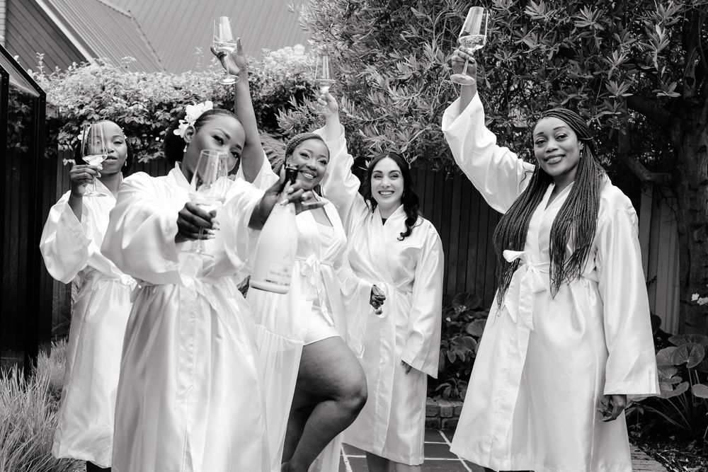 A group of people dressed in white robes stand together in what appears to be a religious or ceremonial gathering.