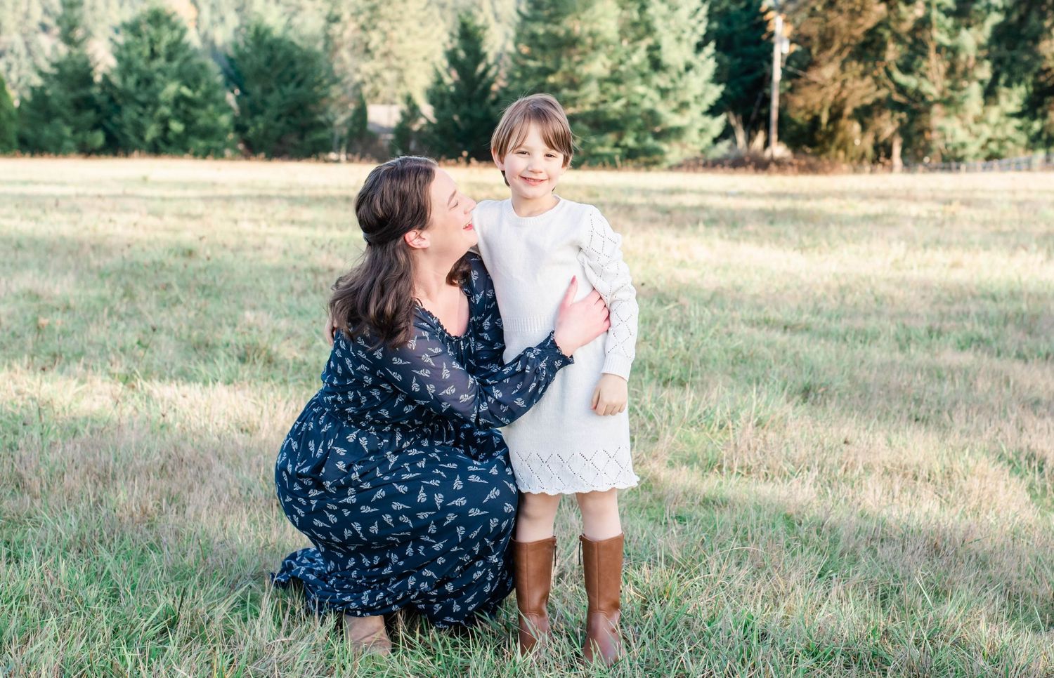 A sweet family moment captured in a series of outdoor photos on a sunny grassy field.