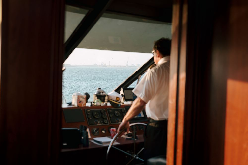 Captain of the Crystal Coast Lady during a wedding celebration. Beaufort North Carolina Wedding Photographer