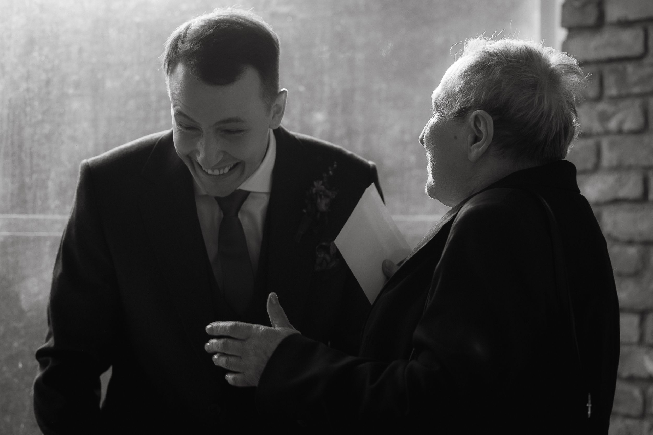 A series of black and white photographs showing people in business attire engaged in professional conversations.