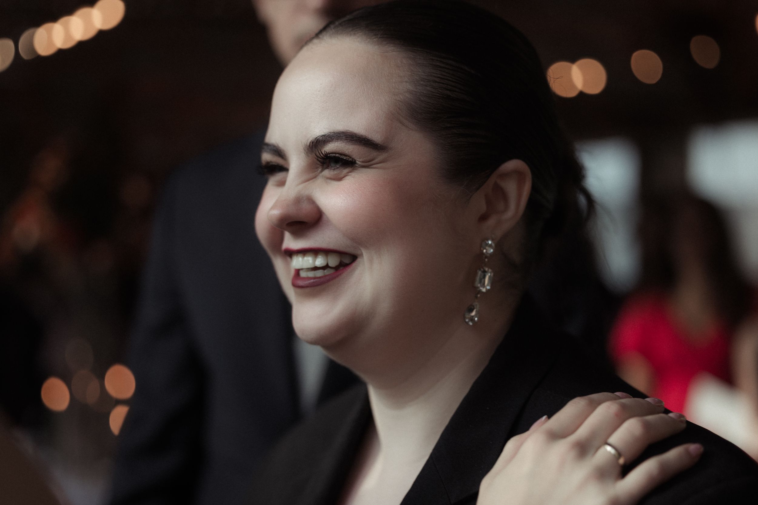 A candid moment of joyful laughter captured during an evening celebration.
