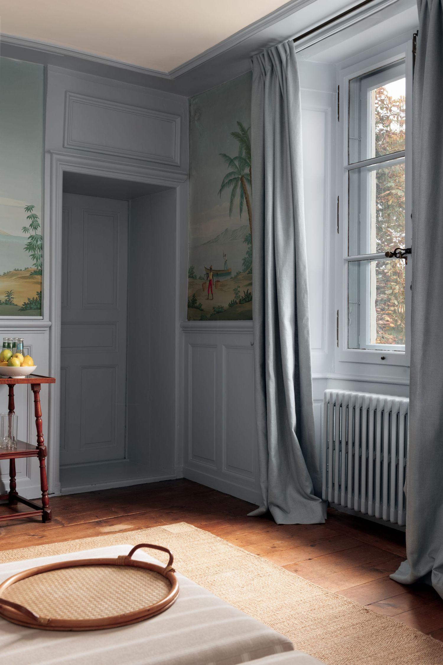 Pale Blue Room with painted murals and window onto the autumn trees.  Interior photography for Sofia Clara Interiors, Switzerland