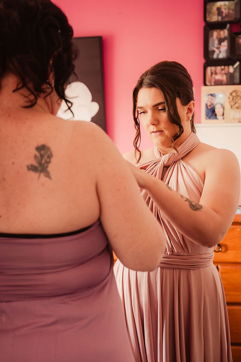 A series of pink-tinted photos showing a person in a mauve dress with a visible butterfly tattoo on their back.