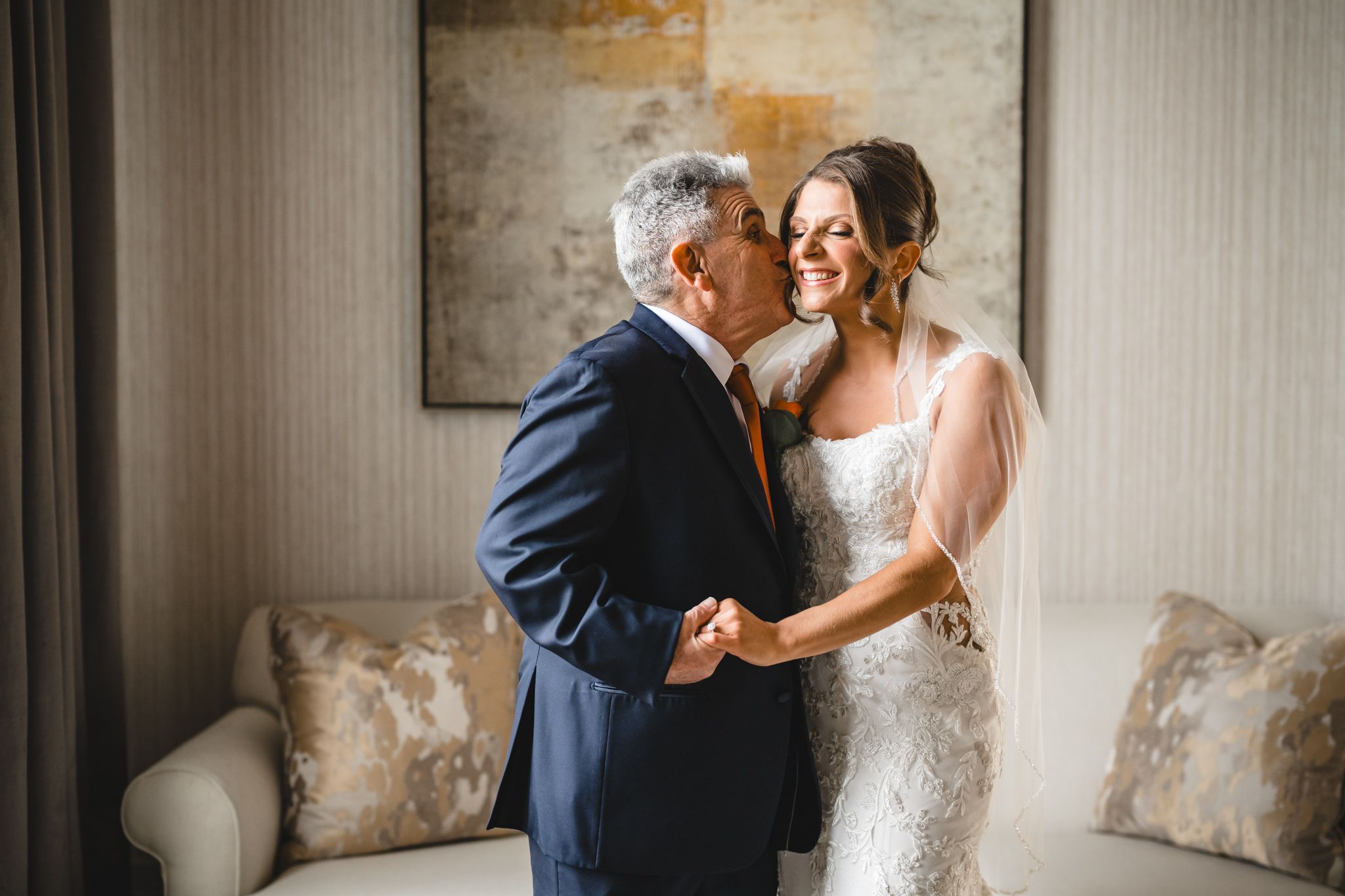 Emotional first look sequence showing heartfelt reactions in a light-filled room with textured walls.