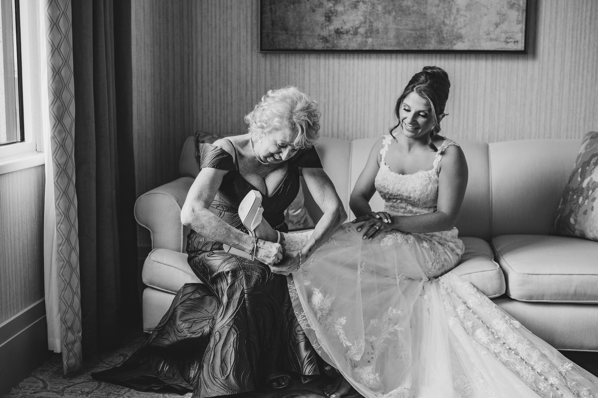 Elegant bridal portraits in a light-filled room with white furniture and textured walls.
