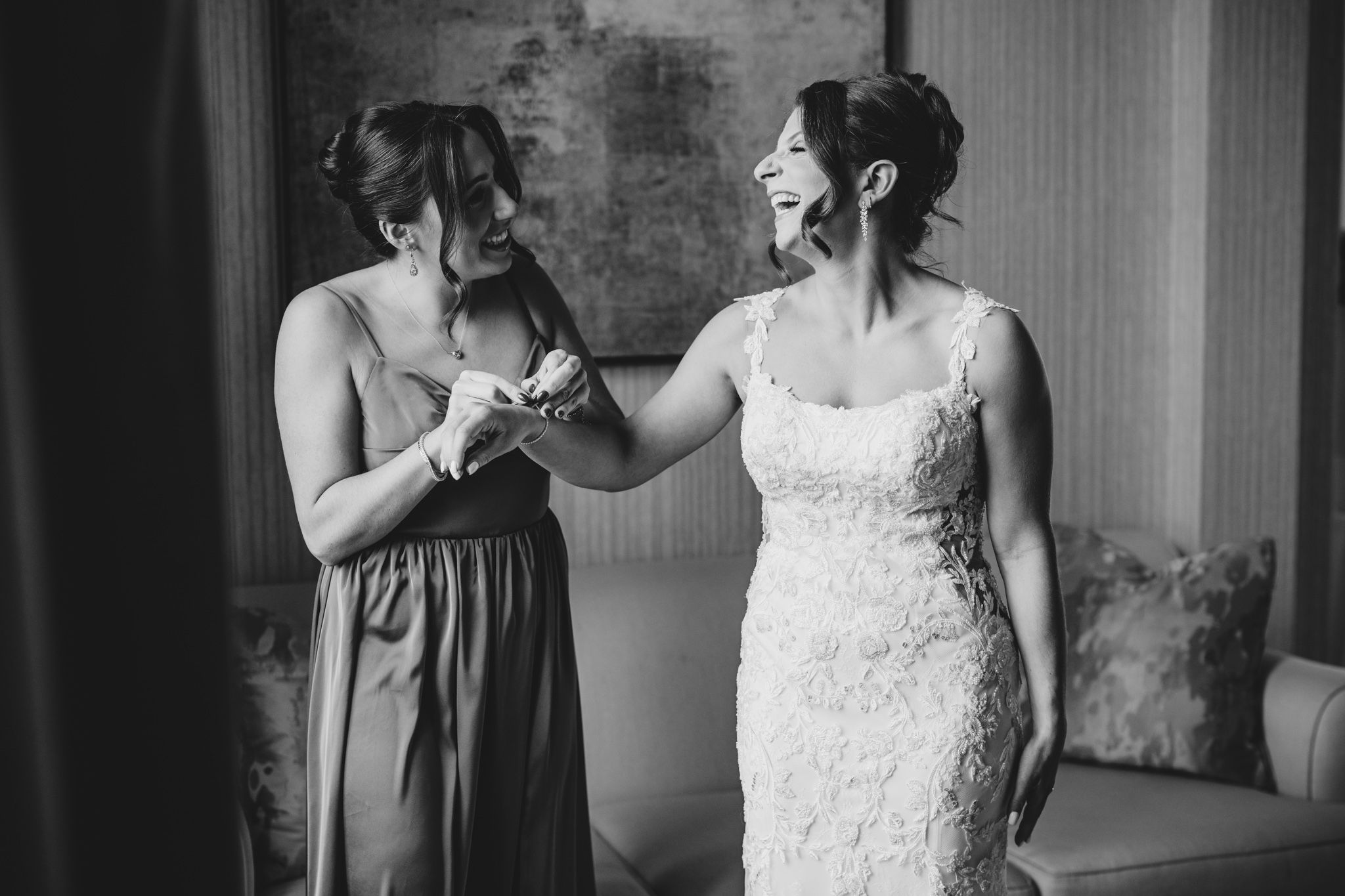 Black and white series capturing tender wedding day moments against a modern interior backdrop.