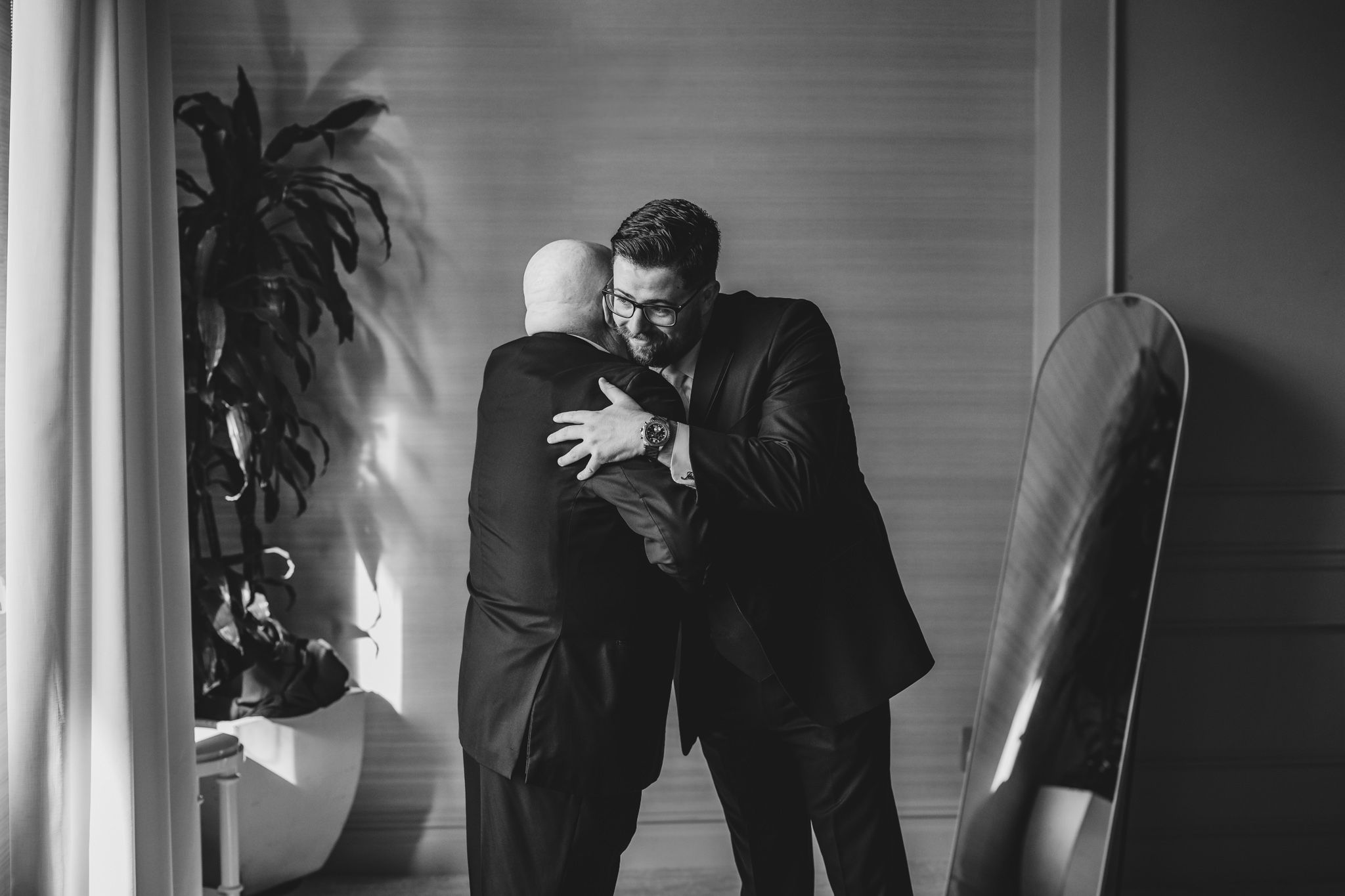 Dramatic black and white sequence of wedding party preparations in a modern interior space.