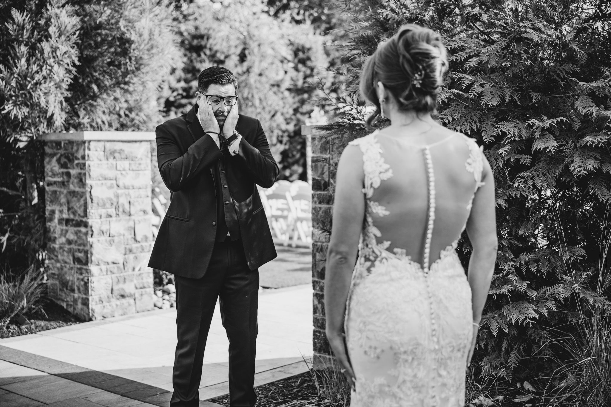 Black and white wedding portraits captured in an outdoor garden setting.