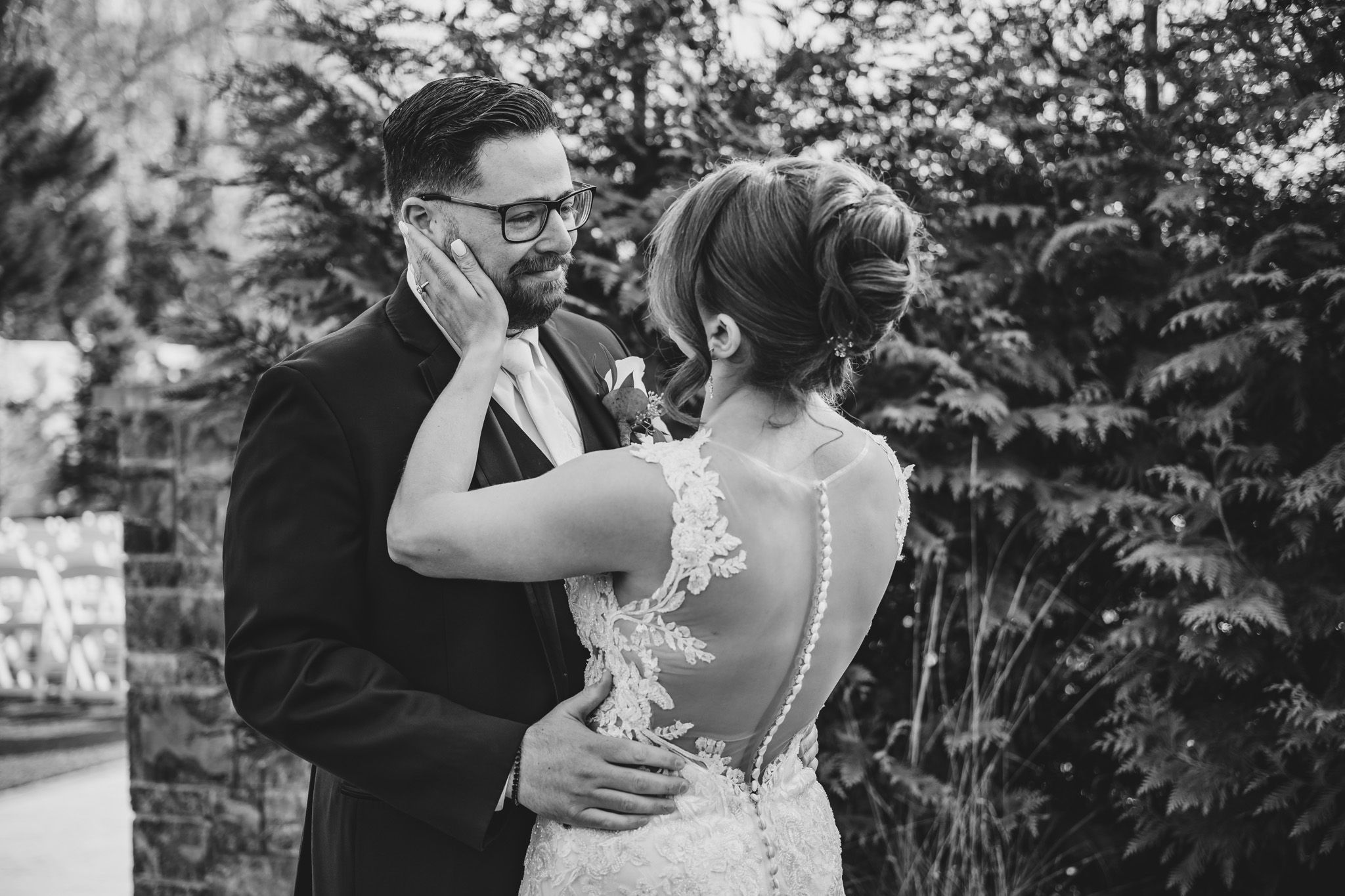 Black and white portrait of couple sharing emotional first look moment.