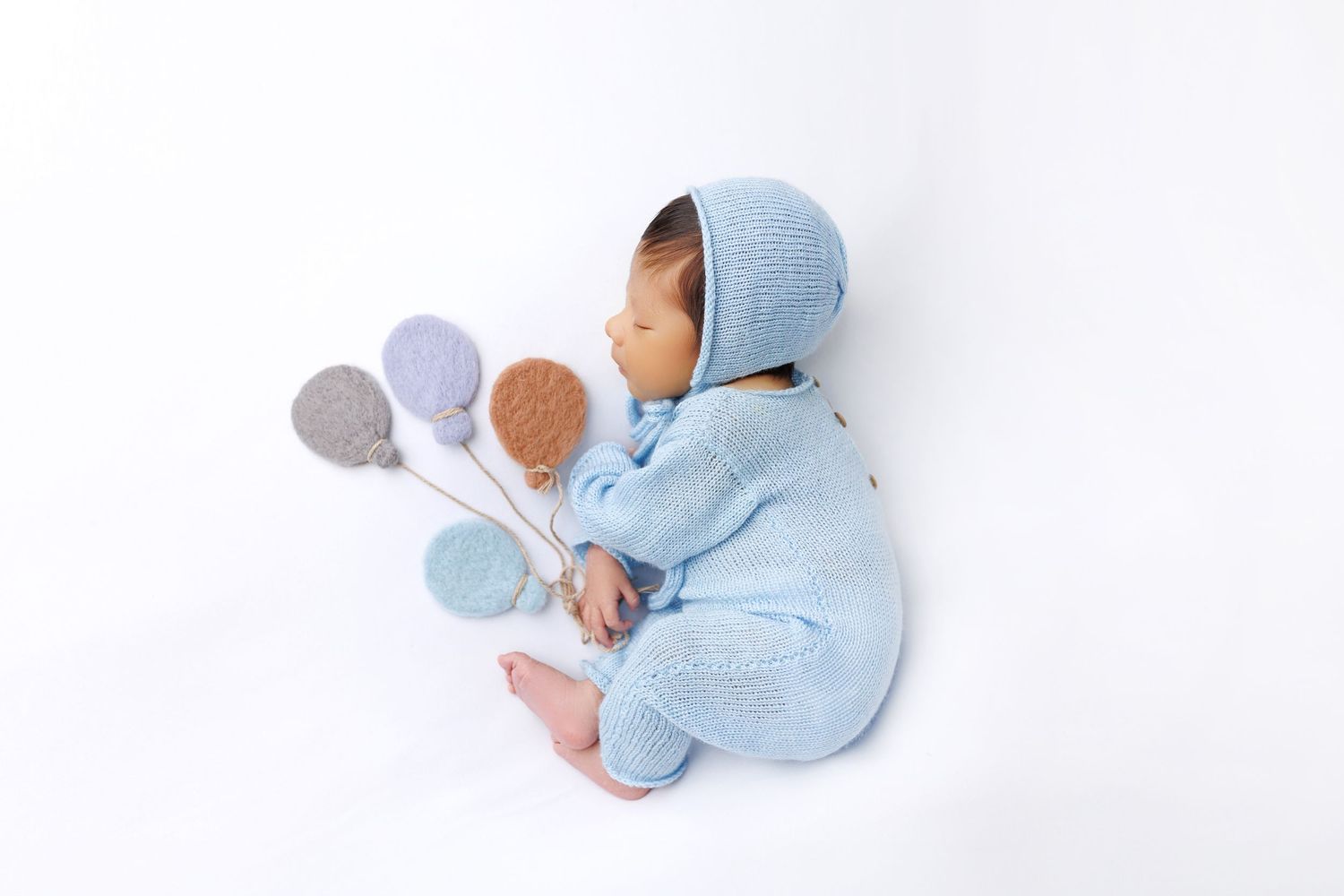 A blue plush bunny toy lying in different positions on a white background.