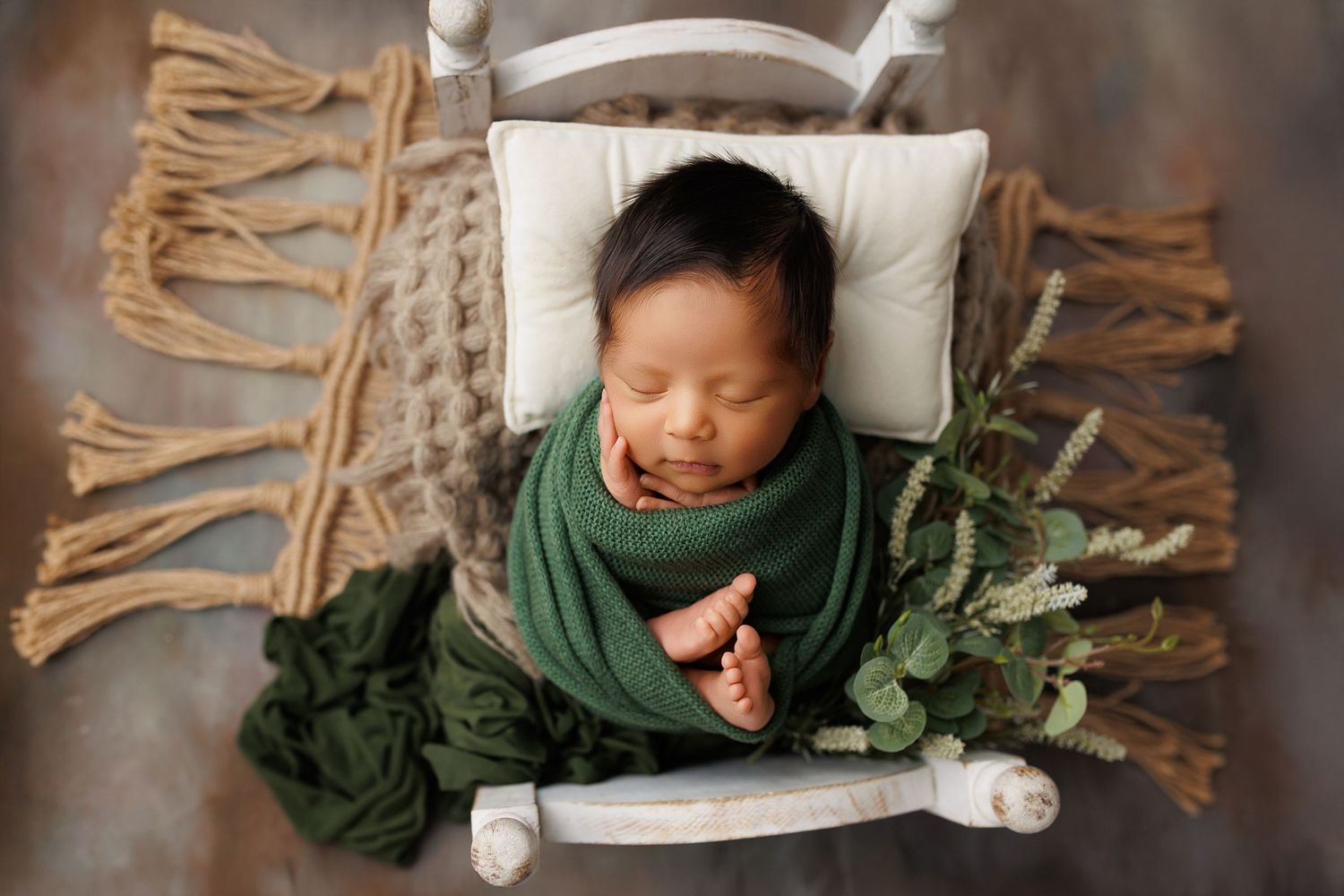 A sleeping figure rests peacefully on a white pillow wearing a dark green garment.