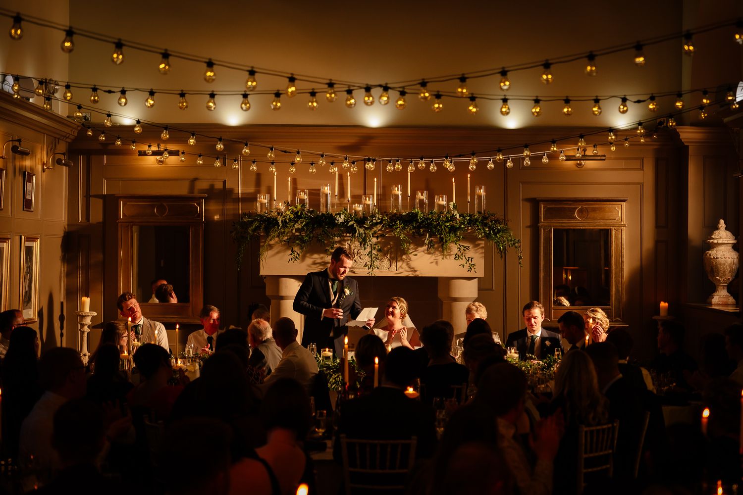 Wedding reception venue with warm string lights creating an intimate ambiance.