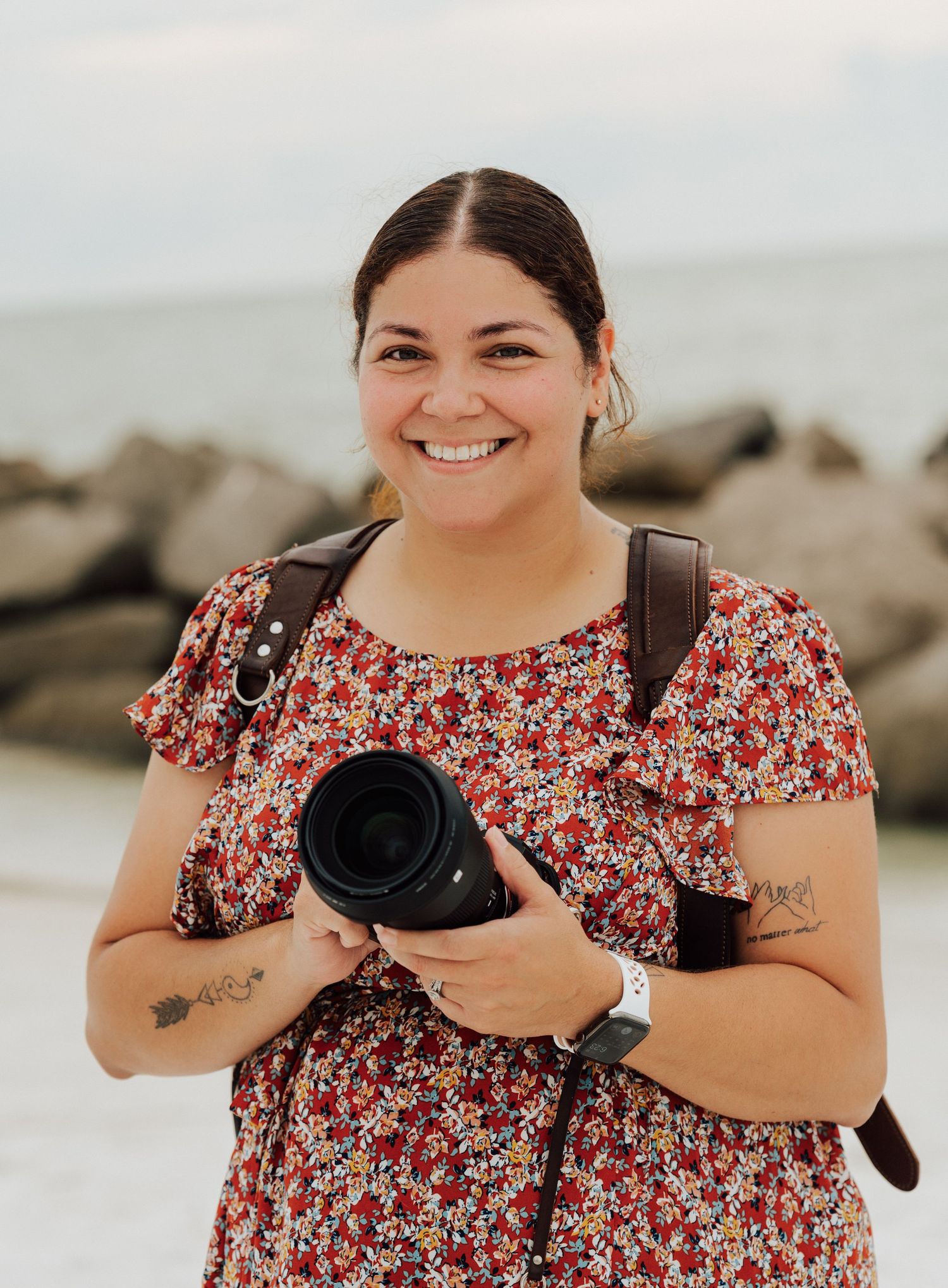Nicolle Aponte Photography posing at wedding reception venue smiling