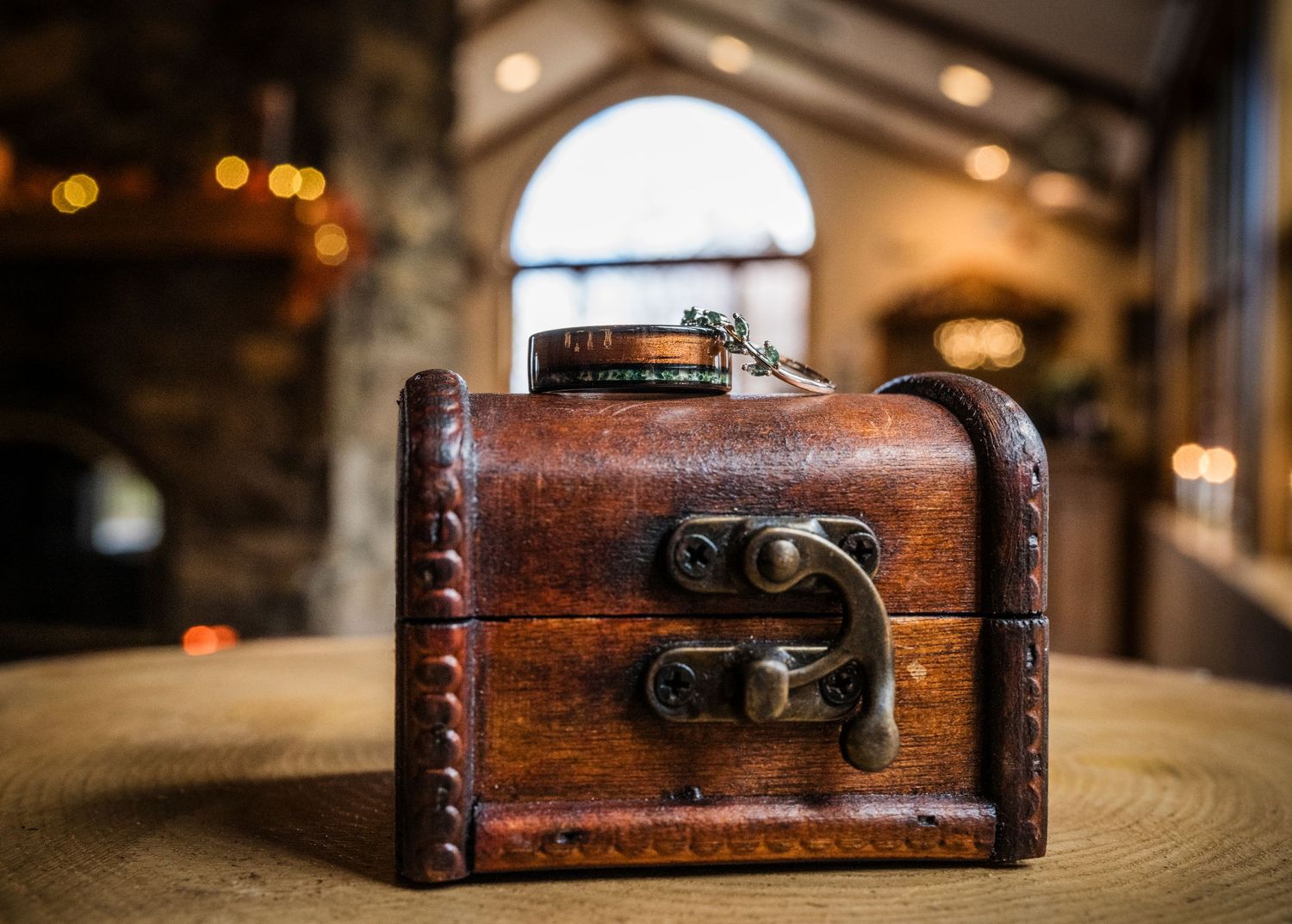 A vintage wooden treasure chest with metal clasps shown from different angles in a series of photos.