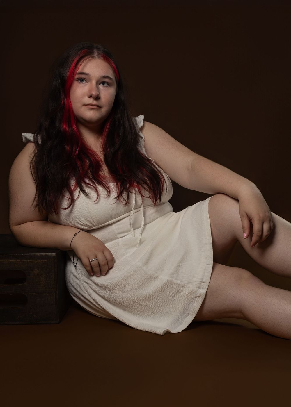 Artistic boudoir photography series on dark background with white dress.