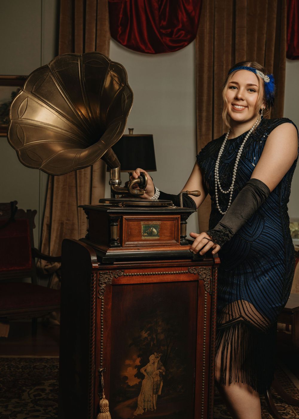 Vintage-themed portrait session with antique phonograph and 1920s styling.