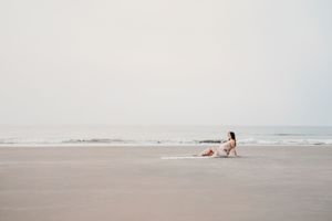 Minimalist beach photography with distant figures against a misty oceanfront.