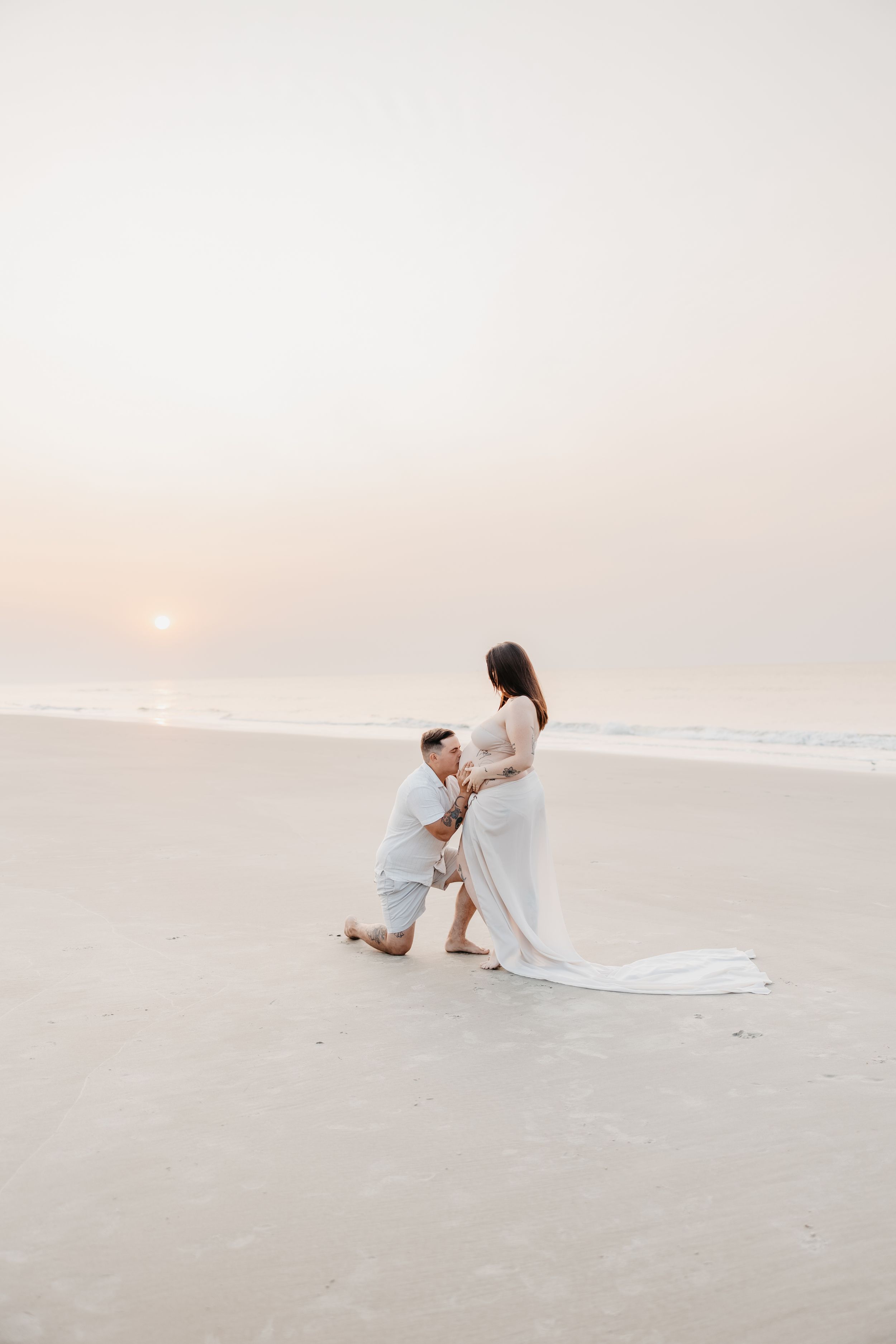 Intimate beach portraits at sunset with flowing white fabric.