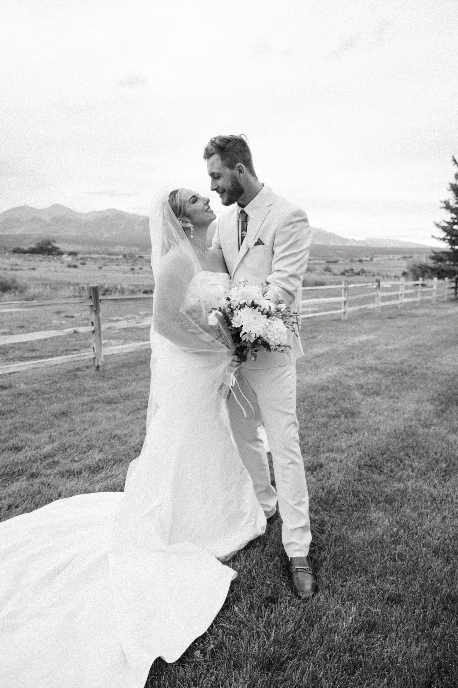 A series of romantic wedding portraits captured in black and white against a mountainous backdrop.