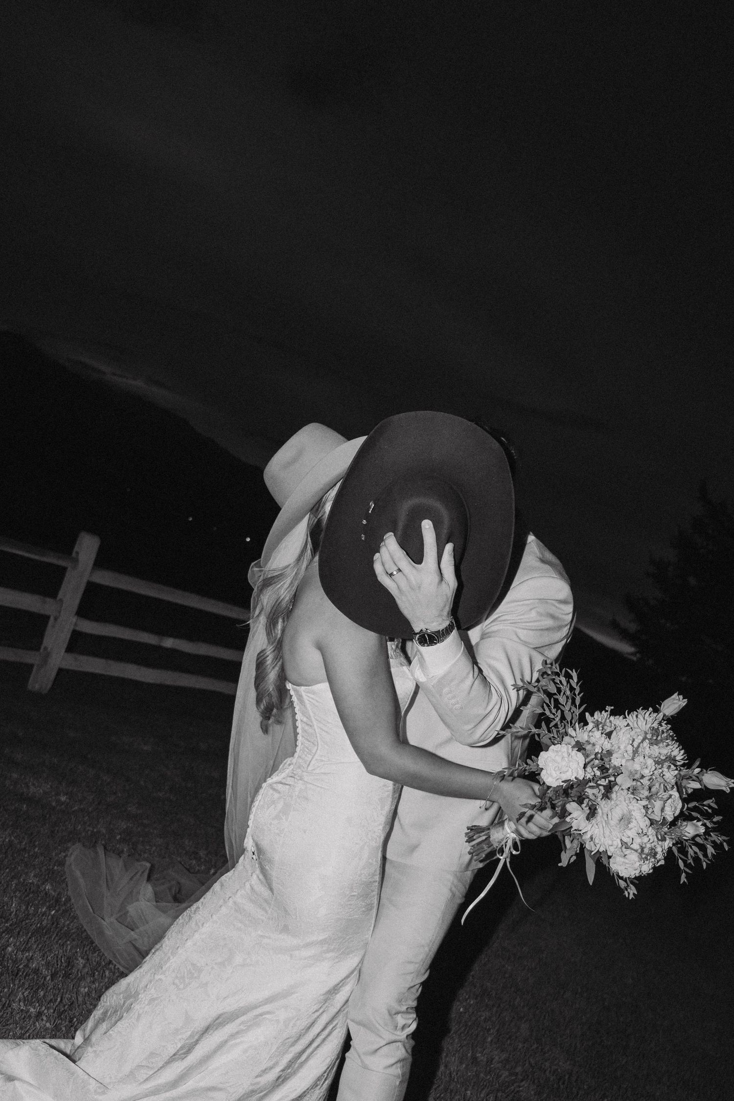 Artistic black and white nighttime wedding photos showing intimate moments between newlyweds.