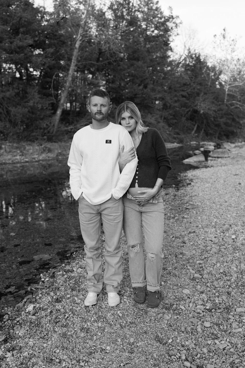 Black and white photo series showing a couple outdoors on rocky terrain near trees.