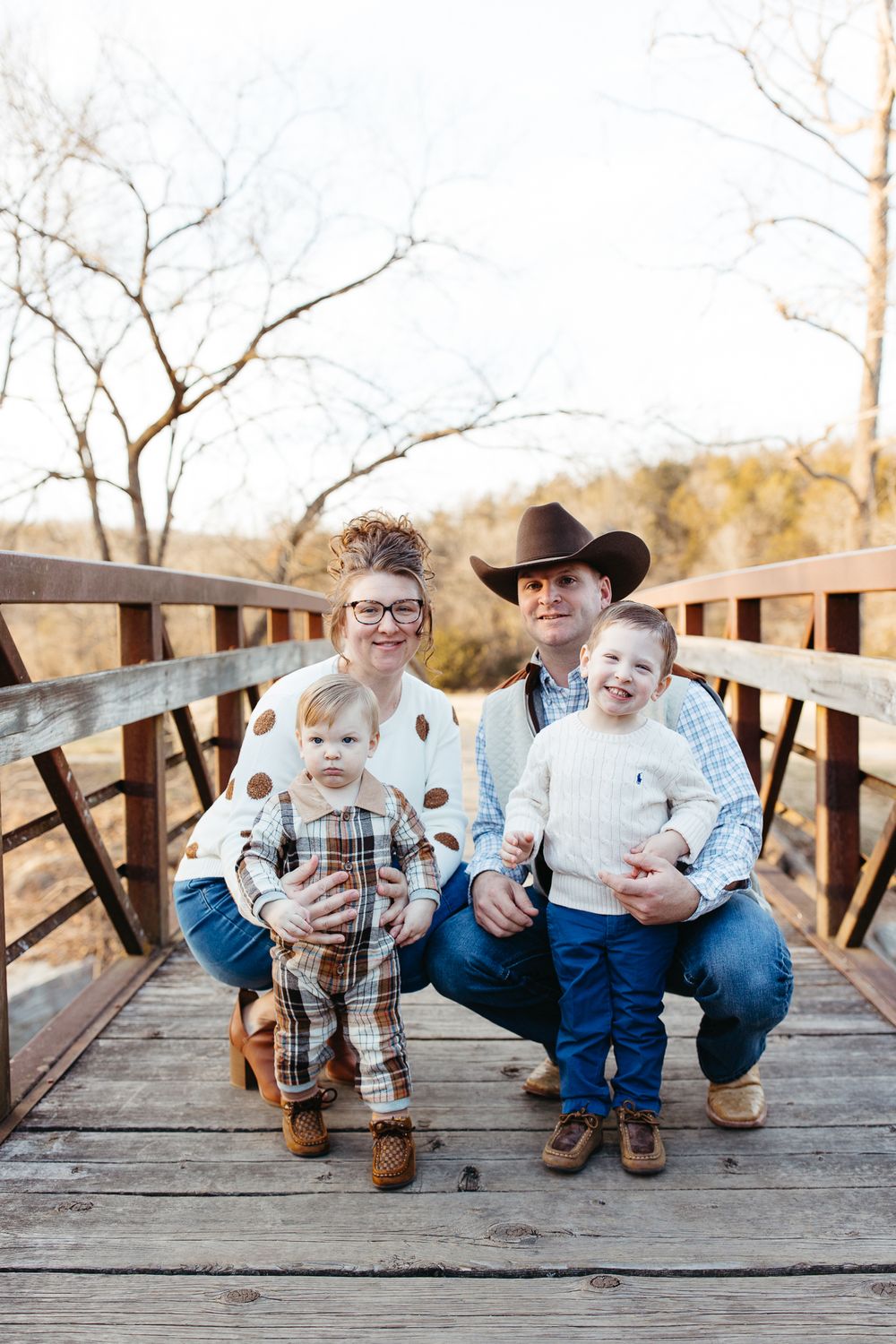 A series of connected photos showing a sweet family moment sitting together on a wooden bridge.