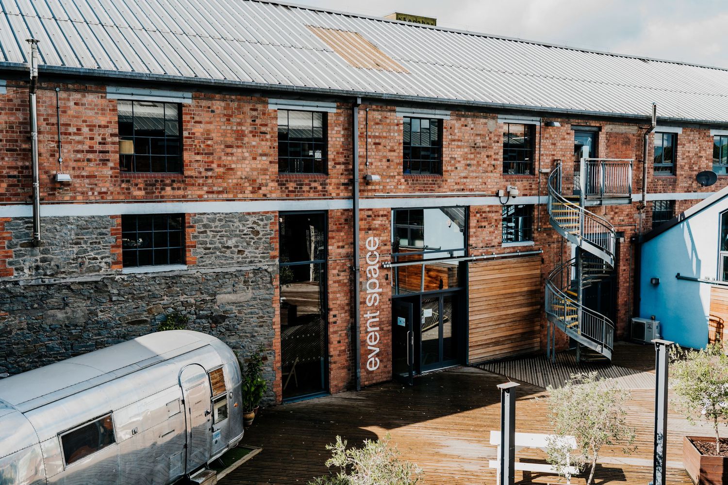 Exterior view of historic brick buildings with industrial architecture and windows.