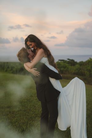 bride and groom posing at sunset at Kauai wedding by Kauai Wedding Photographer