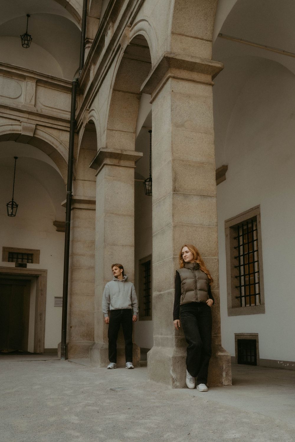 A series of architectural photos showing people posing in a stone archway corridor with beige columns and walls.