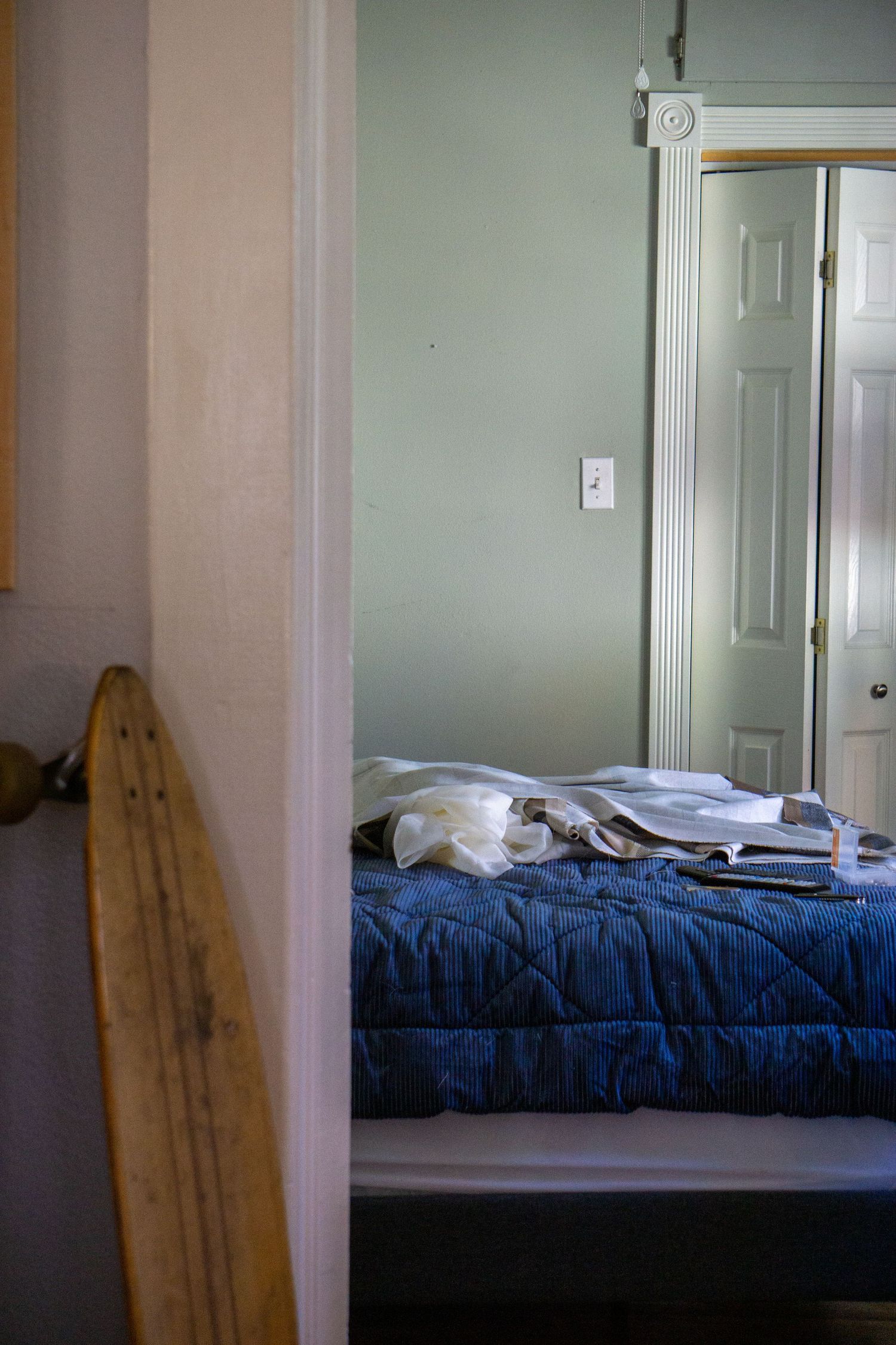 A surfboard, very commercial looking, and a bed