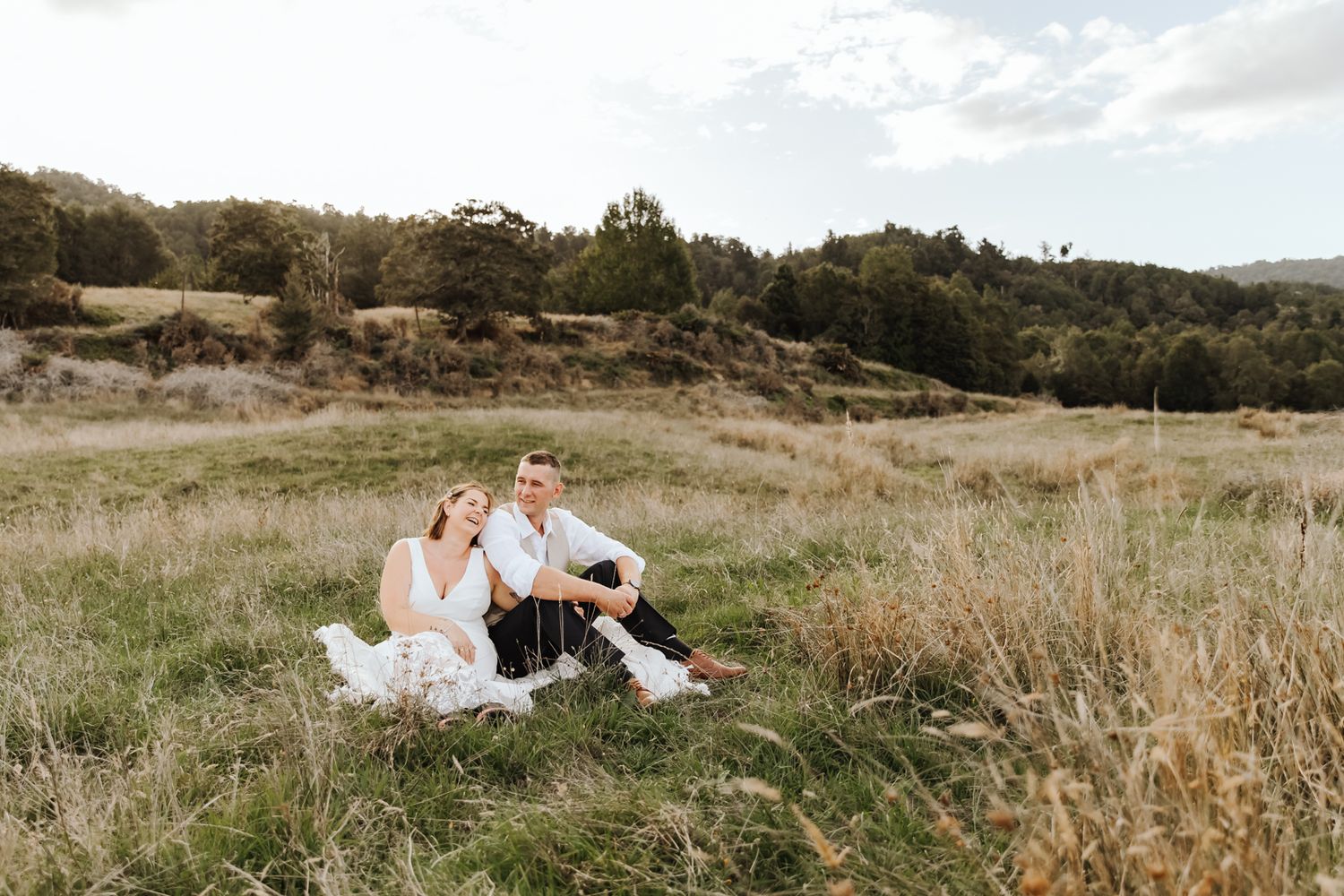 Couple embracing at golden hour during a West Coast NZ wedding photoshoot