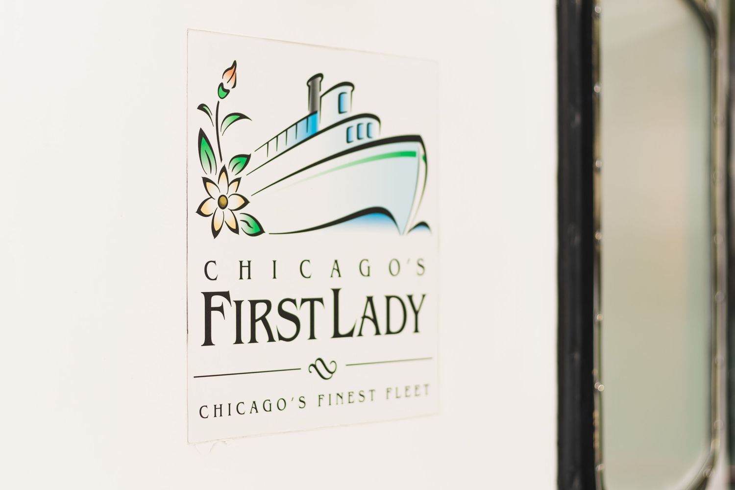 Chicago's First Lady boat logo design featuring simple line drawing of cruise ship with floral accent.