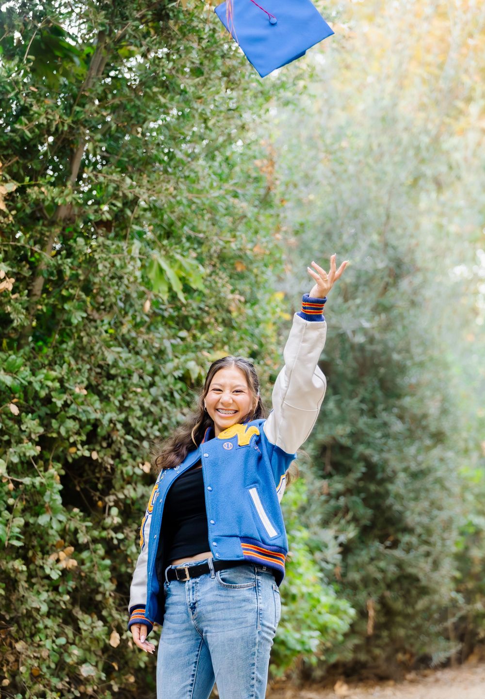 A series of dynamic outdoor photos showing someone in a blue jacket and jeans jumping and posing against a natural backdrop.