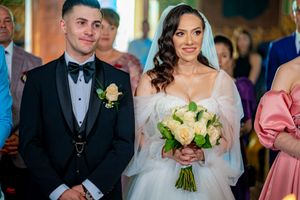 Wedding party members line up during formal ceremony in elegant venue.