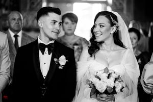 Black and white photo captures intimate wedding ceremony moments.