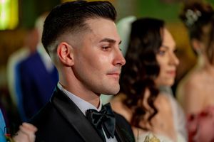 Close-up profile view of attendees at a formal wedding ceremony.