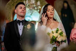 Wedding ceremony in progress with elegant decor and lighting.