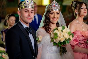 Wedding party members in formal attire during traditional ceremony with floral accents.