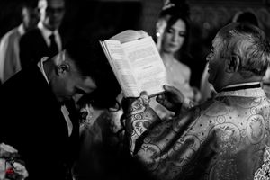 A black and white artistic shot of a wedding ceremony in progress.