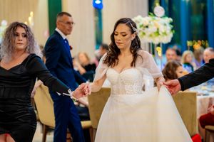 Wedding celebration with dancers in formal attire on dance floor.