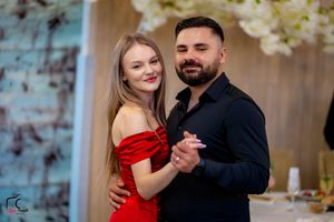 Couples sharing romantic dances at an indoor celebration with mood lighting.