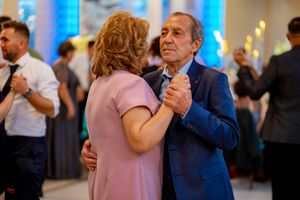 Multiple couples dancing together at a formal indoor social event.